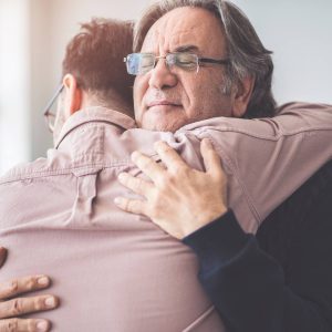 a man hugging another man